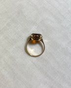 above view of gold ring on white fabric background