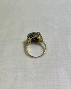 back view of gold ring resting on white fabric background
