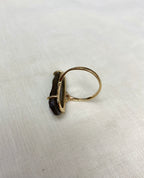large opal ring underneath view on white fabri background