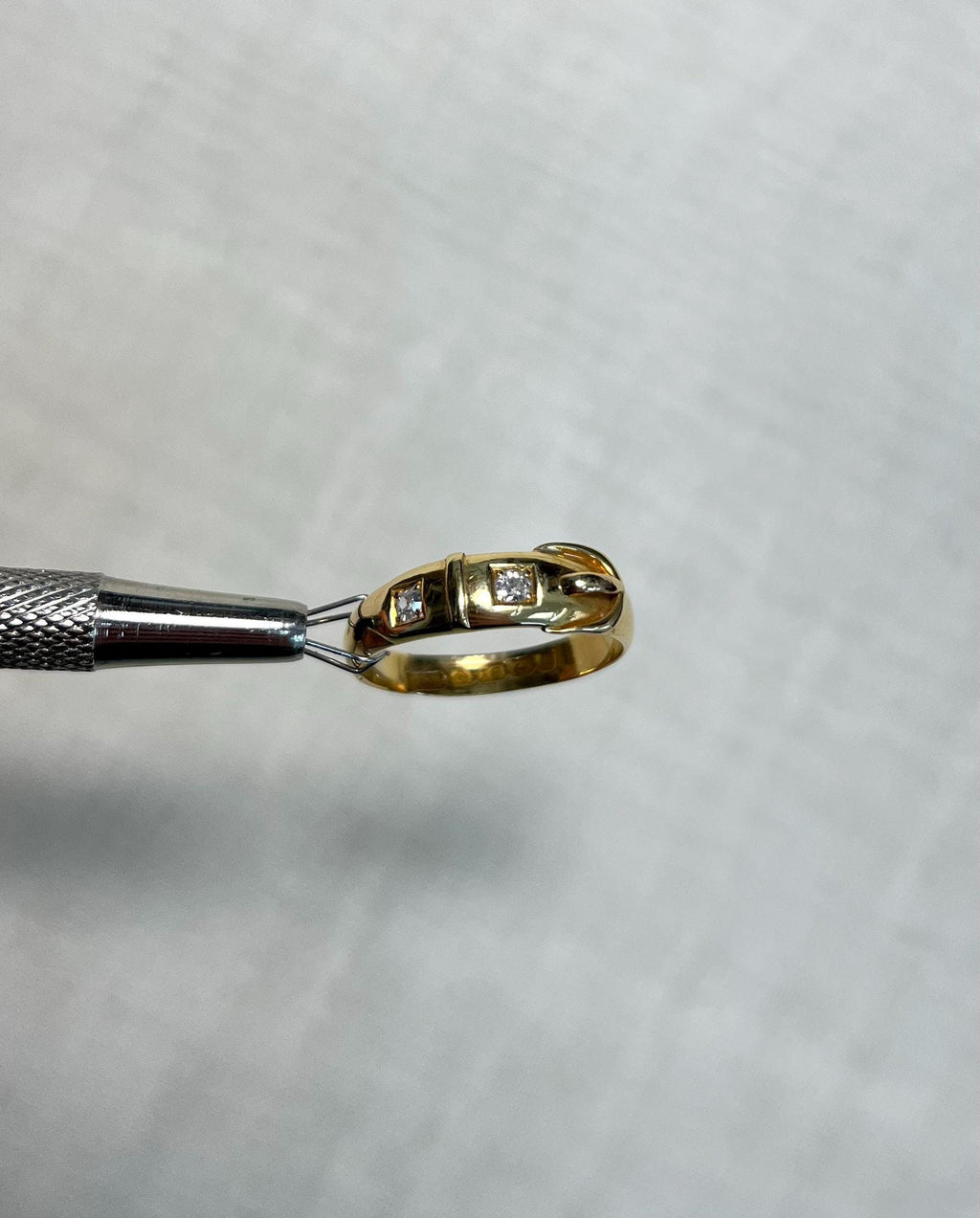 Gold ring with diamonds on a white background