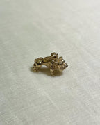 Gold bulldog charm on a light fabric background