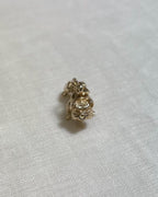 gold dog charm on light fabric background