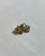 Gold dog-shaped charm on a white fabric background
