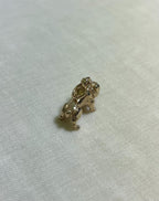 Gold dog charm on a light fabric background