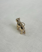 Gold bulldog charm on a light fabric background
