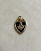 gold Masonic pendant on a white fabric background