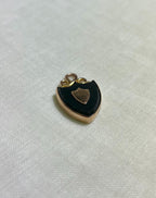 gold shield shaped pendant with deep green almost black bloodstone, on white fabric background