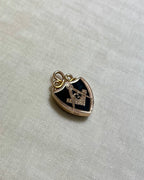 gold shield pendant set with dark green bloodstone and gold masonic compass design, on white fabric background