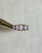 Ring with opal stones on a white background