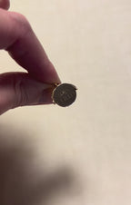 a gold round charm being spun to reveal happy birthday message