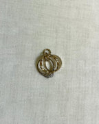 3 gold ring charm on white fabric background