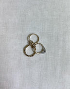 3 gold ring on white fabric background
