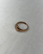 rose gold ring on white fabric background