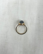 top view of gold ring on white fabric background 