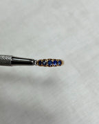 gold ring with blue gemstones on a white background