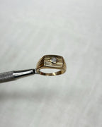 Gold ring with a diamond on a white background