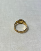 back view of gold double band ring, resting on white fabric background 