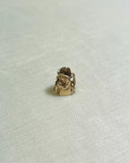 small gold toby jug charm on cream background