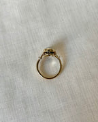 above view of gold ring resting on light beige fabric background 
