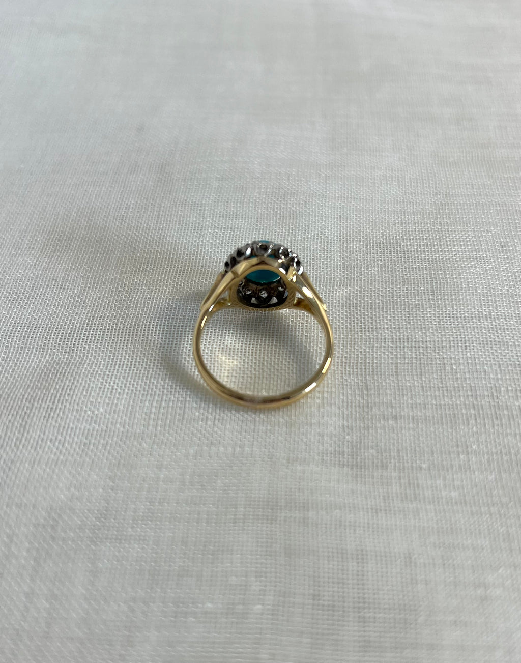 back view gold ring on beige fabric background